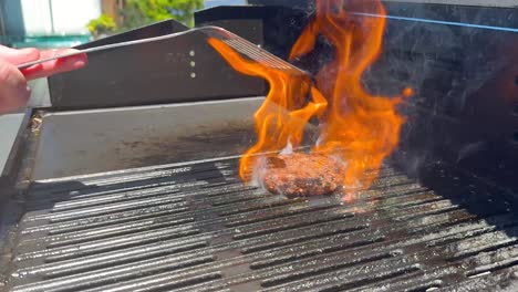 cooking hamburger patty on a barbecue grill