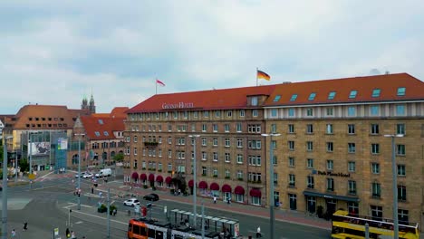 4k aerial drone video of trains in front of the grand hotel in downtown nurnberg, germany