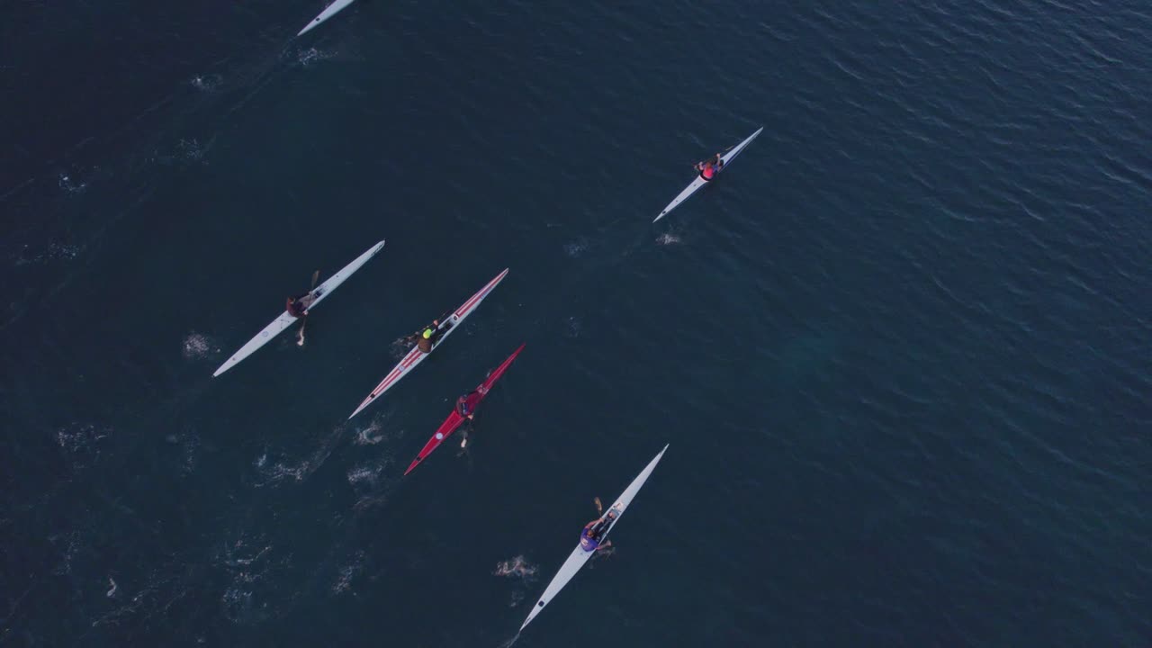 Top down of group kayaks paddling on calm ocean at Mallorca, aerial