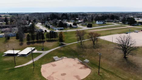 aerial shot of a baseball field right next to a neighborhood