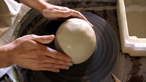 mid section of potter making pot