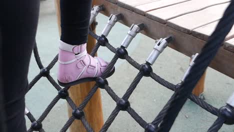 child climbing playground rope net