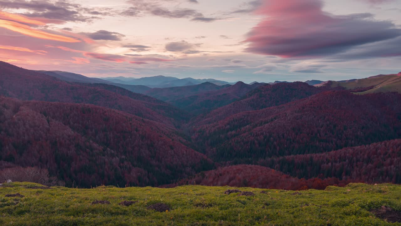 Sunset timelapse on mountain range in Navarra Pyrenees over Irati forest and mountains orange sunset glow and soft light