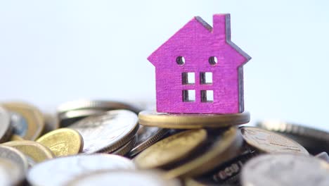 pink house on a stack of coins