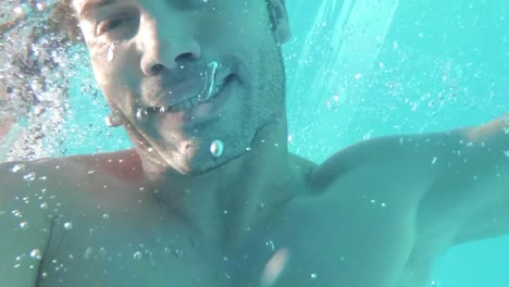 handsome man heading out of the pool