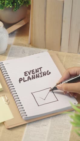 vertical video of ticking off event planning work from checklist