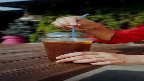 woman enjoying iced coffee outdoors