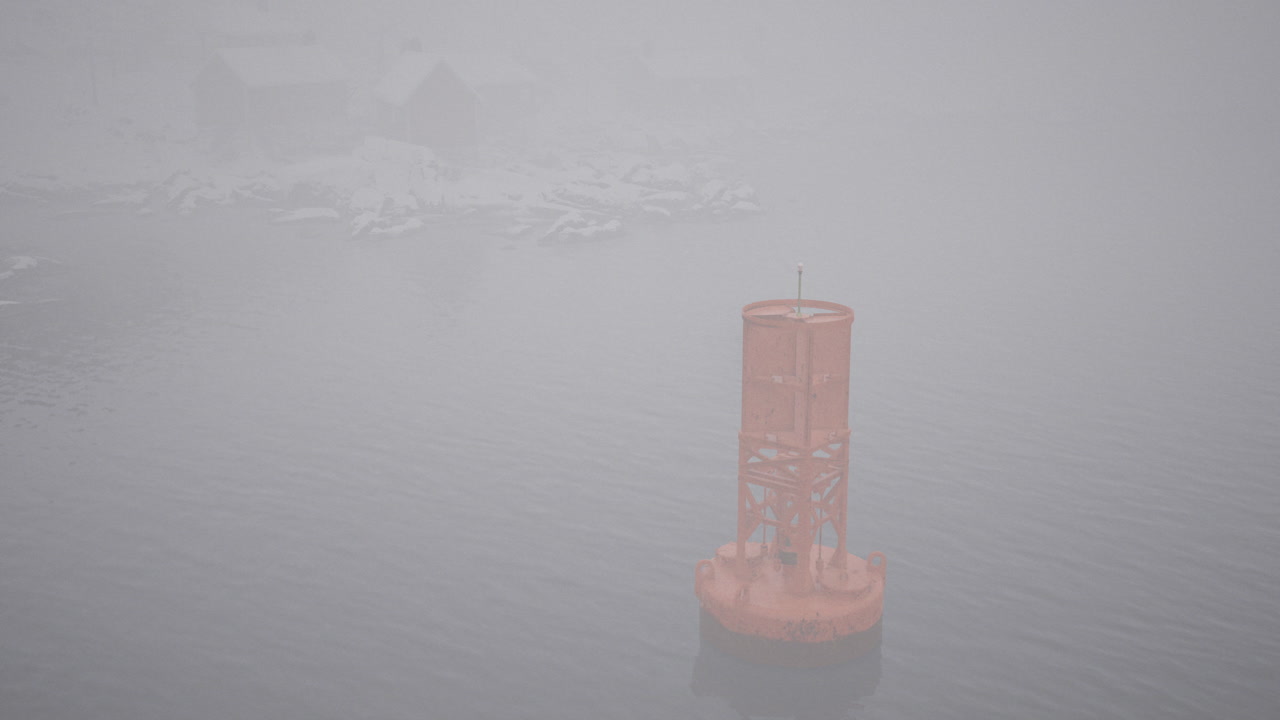 Misty ocean view with a buoy standing in the fog during early morning hours
