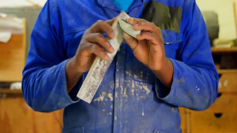 mid section worker working in foundry workshop 4k