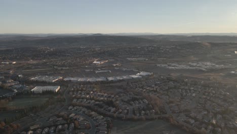 drone birdseye footage on a misty bright early morning over folsom, tahoe, usa, with misty mountains in the distance