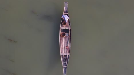 aerial view of asian fisherman fishing on wooden traditional boat