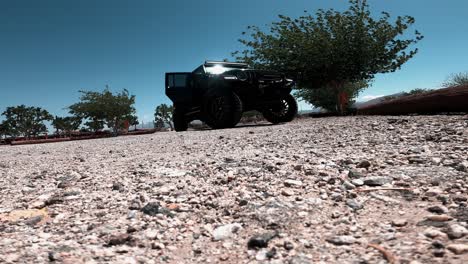 low angle of a black jeep gladiator with door opened and small wind in california