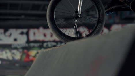 active bmx rider jumping on bicycle outdoors. guy performing jump stunt.