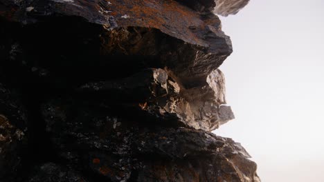 camera moving around rockformation close up with orange moss