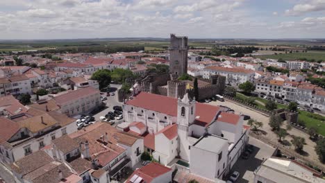 aerial view of cityscape, wall fortifications and castle of beja, portugal, circling shot