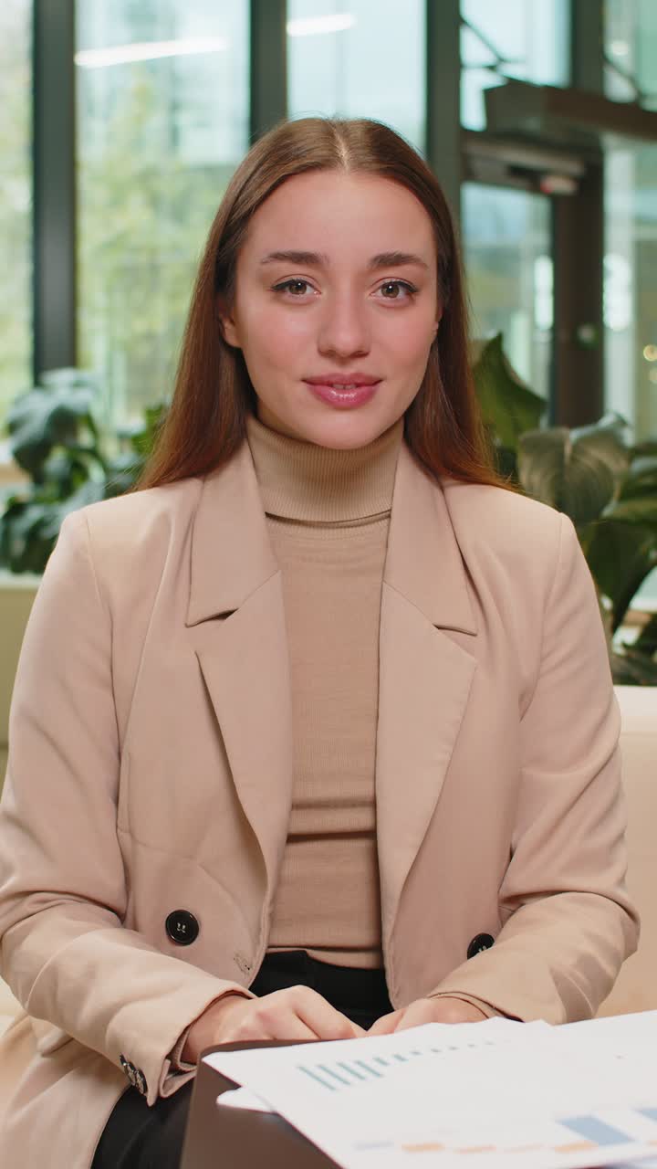 Portrait of smiling caucasian young businesswoman girl in formal showing thumb up in hotel lobby