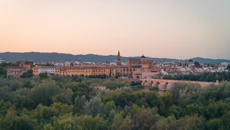 Sunset-panoramic-view-day-to-night-timelapse-of-Cordoba-city-Mezquita-Mosque-cathedral-and-roman-bridge-during-summer