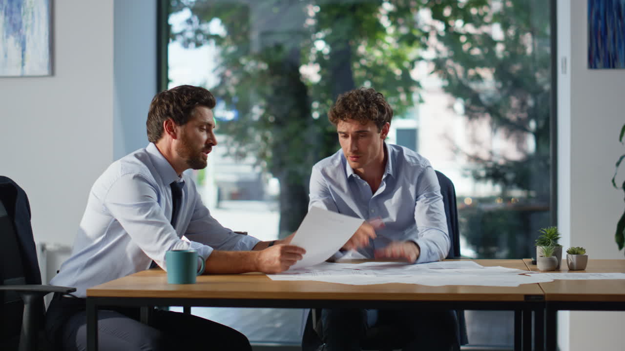 Business people discussing documents at office closeup. Colleagues speaking