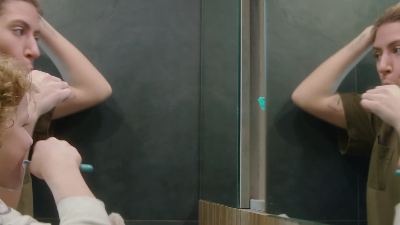 Mother Teaching Son How to Brush Teeth in Bathroom