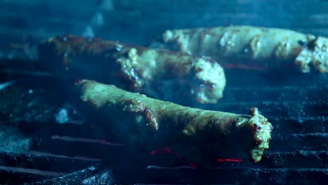 closeup of three chorizo sausages on a hot grill