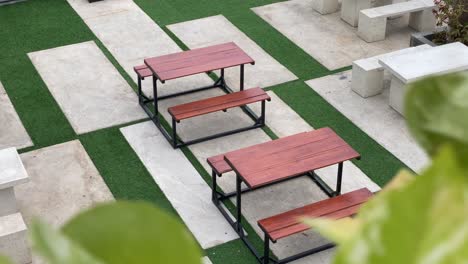 the footage shows the coffee shop's outdoor concept customer tables and chairs, using modern aesthetic stone and wood.