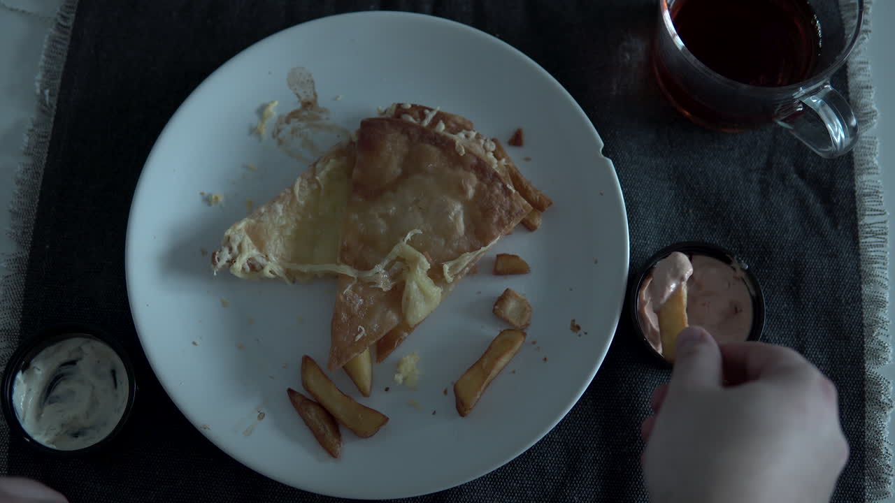 Eat your hand fries and soak in the sauce, a dish on a white plate at the home table, top view