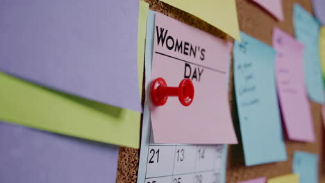 women's day reminder on corkboard