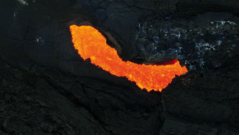 Boiling-magma-flowing-through-lava-tubes-under-a-layer-of-cooled-lava,-aerial