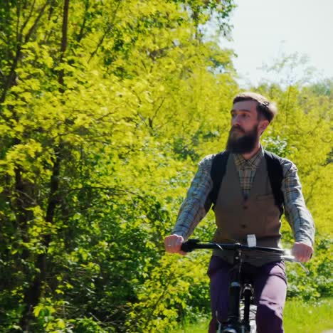 Bearded-Hipster-Riding-On-A-Bike-On-A-Clear-Spring-Day-1