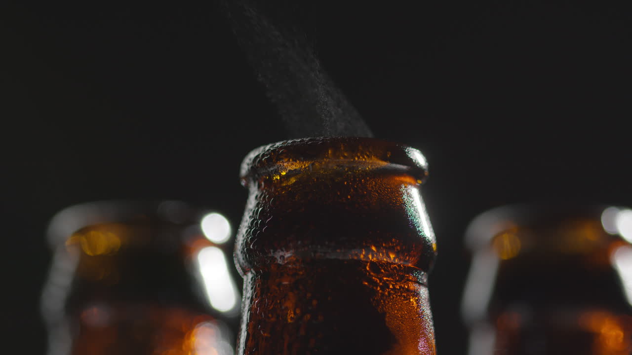 Close Up Of Condensation Droplets On Neck Of Bottles Of Cold Beer Or Soft Drinks With Water Vapour After Opening 3