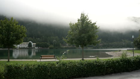 Beautiful-wide-shot-of-famous-clear-austrian-Achensee-lake-during-foggy-cloudy-day-early-in-morning