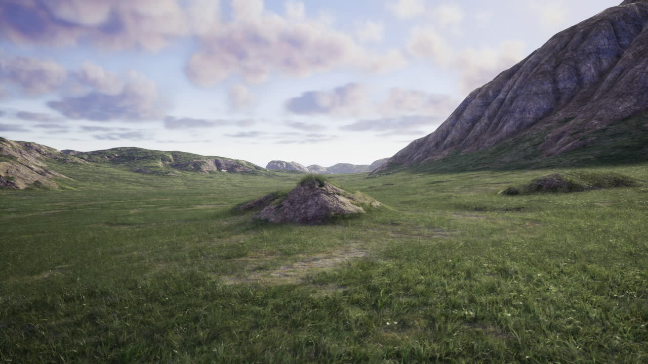 Vast green landscape with rocky formations under a cloudy sky during midday