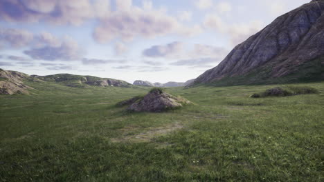 vast green landscape with rocky formations under a cloudy sky during midday