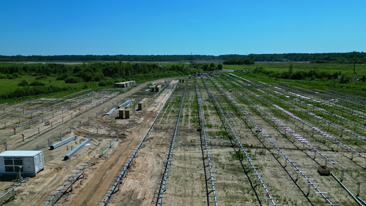 Solar panel farm field in middle of countryside, aerial view