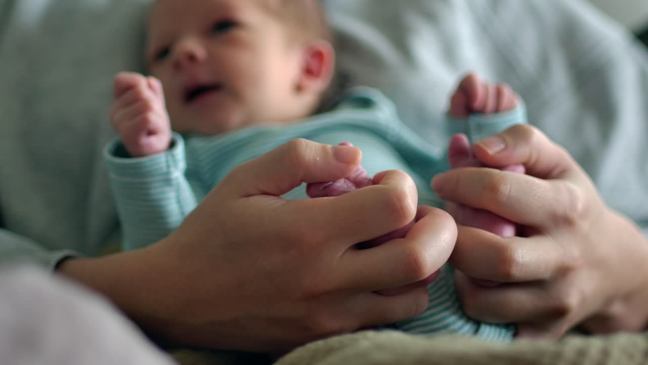 Mother Holding Baby's Feet - Focus on Hands SLOMO