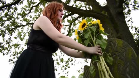 A Solemn Tribute: A Person Laying Sunflowers at a Grave, Signifying Remembrance and Honor in Nature&#039;s Embrace Amidst a Serene Landscape
