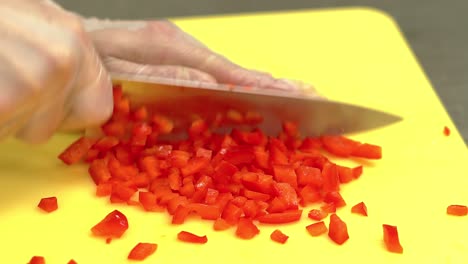 CU-Slow-motion-Cook-very-quickly-cuts-fresh-Bulgarian-peppers
