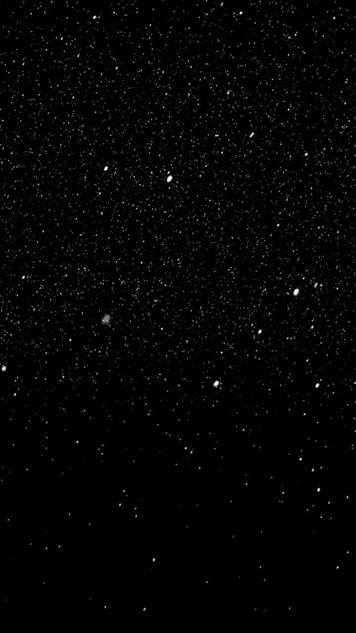 Particles of snow falling from sky