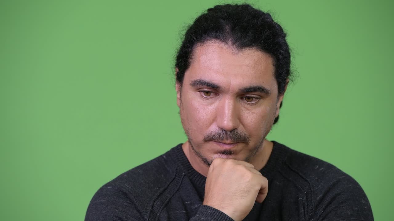 Serious man thinking while looking down