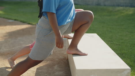 medium shot of womens legs stretching in park