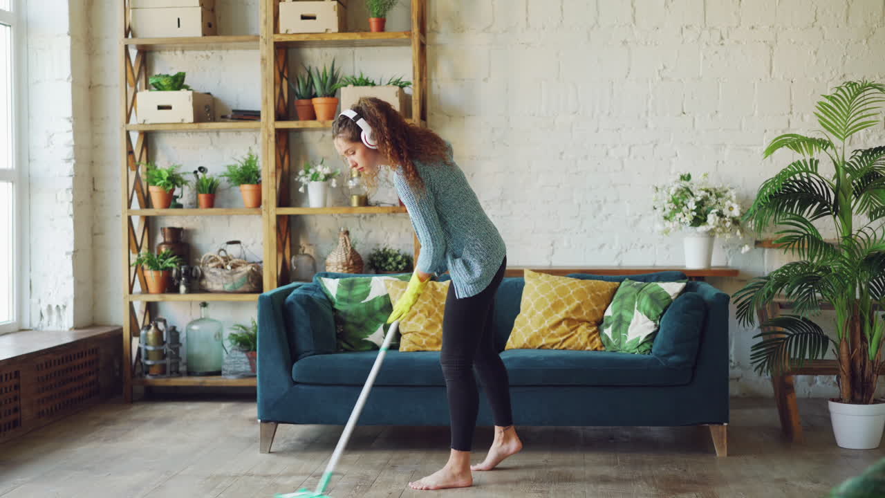 Woman Mopping the Floor in a Modern Living Room