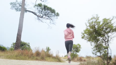 woman running trail steadicam shot