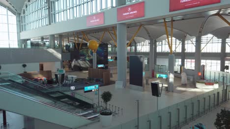 In the daytime, a shot of the descending staircase and departing corridor at Istanbul Airport&#039;s departure terminal