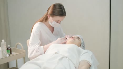 cosmetologist performing facial injection procedure