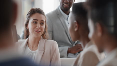 young caucasian business woman chatting with colleagues in office meeting having conversation sharing ideas in corporate workplace