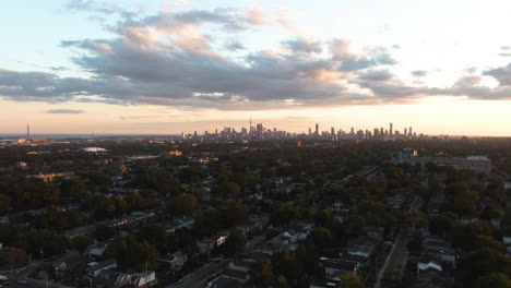 a panoramic view of toronto in the early evening hours: green eastside is also covered with cloudy sky