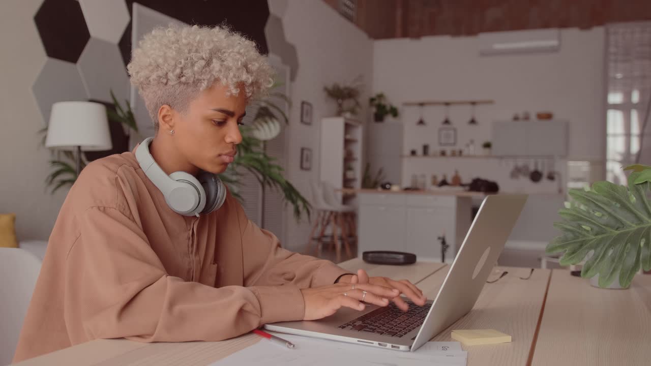 Individual works on laptop in a modern home office space