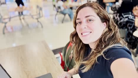 happy student with laptop on university campus