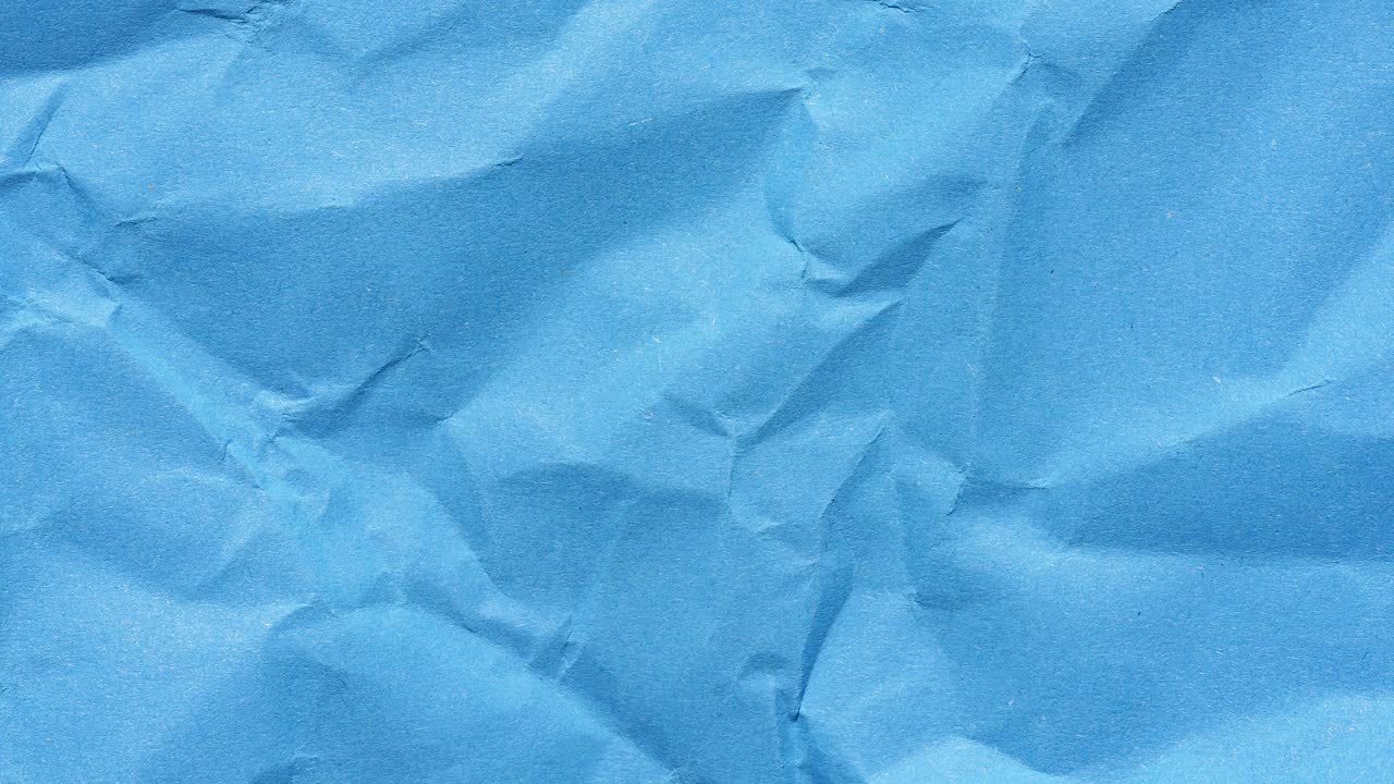 Stop motion animation of wrinkled textured blue paper background