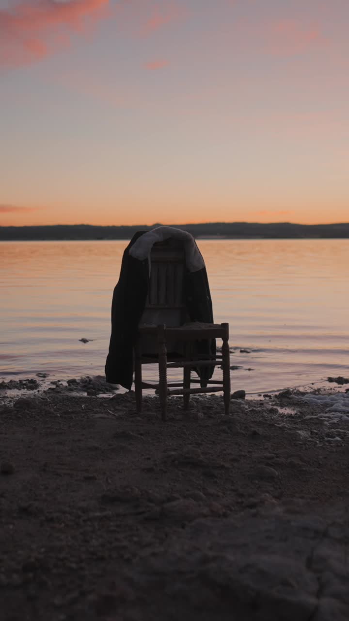 Jacket on a Chair by the Water at Sunset